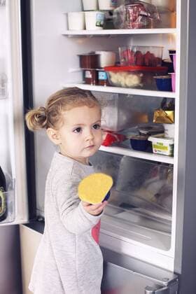 Little girl taking food out of refrigerator  Copyright: Anne-SophiexBost B30304339
