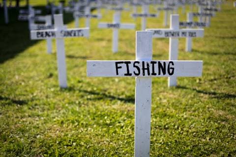 White crosses in mock cemetery commemorating local activities and oil spill protests, Grand Isle, Louisiana, USA, Grand Isle Louisiana USA Copyright: SteelexBurrow BUST001236