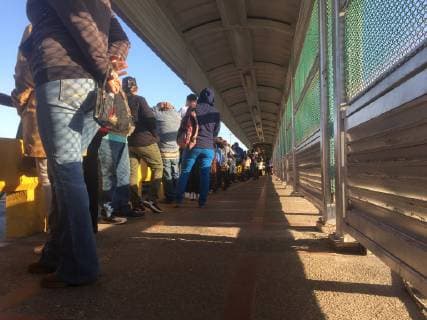 Pedestrians line up for U.S. immigration between Matamoros, Mexico and Brownsville, Texas on January 10, 2019 in Matamoros, Mexico, the day of President TrumpÕs visit to the Border.  MBX20190110203 PATRICKxTIMMONS