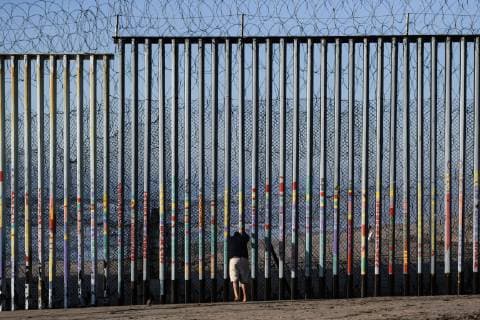 (190111) -- TIJUANA, Jan. 11, 2019 -- Aerial photo taken on Jan. 10, 2019 shows a man in front of the U.S.-Mexico border barrier in Tijuana, Mexico. A large number of migrants from Central America have failed to detour around the border barrier to enter the United States. ) MEXICO-TIJUANA-MIGRATION-BORDER-U.S. XinxYuewei 