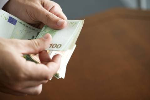 Hands counting stack of cash, cropped  Copyright: FrédéricxCirou B40276926