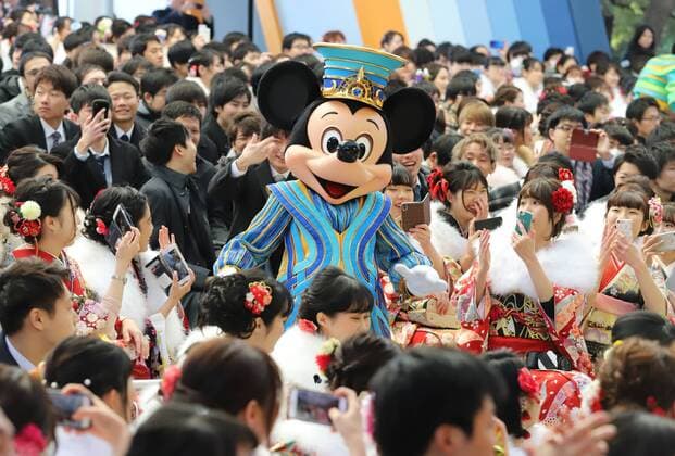 January 14, 2019, Urayasu, Japan - Disney character Mickey Mouse smiles with 20-year-old women wearing kimonos during the ceremony of their Coming-of-Age Day celebration at the Tokyo Disneyland in Urayasu, suburban Tokyo on Monday, January 14, 2019. The number of people aged 20 years old, the legal age of adulthood in Japan, is estimated to stand at 1.25 million this year.  (94998275)