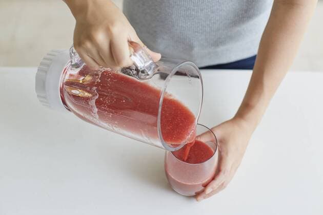 Japanese woman making smoothie in the kitchen  (87984548)