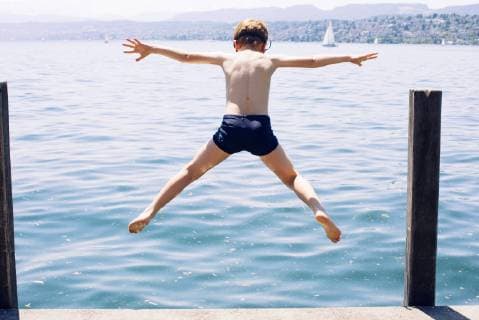 Boy jumping into lake  Copyright: Anne-SophiexBost B57715131