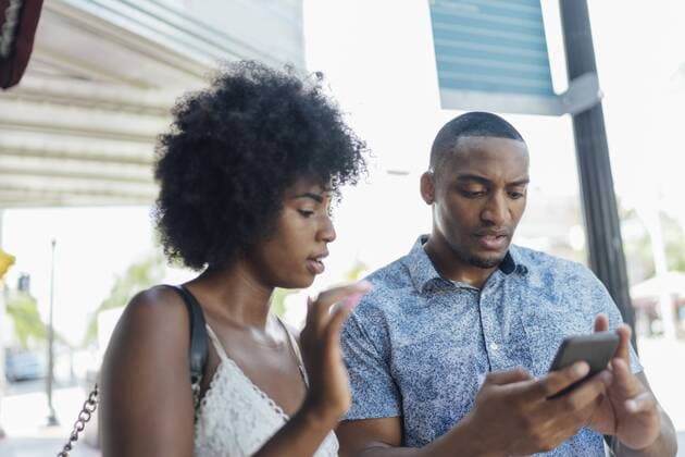 USA, Florida, Miami Beach, young couple using cell phone in the city model released Symbolfoto  BOYF00838