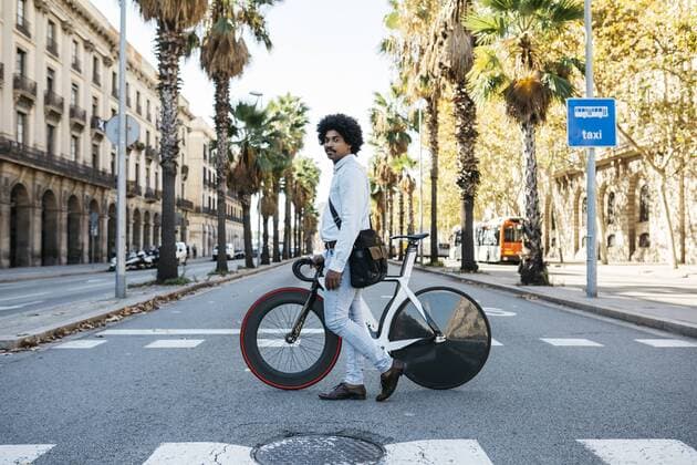 Man pushing his bicycle, crossing a road model released Symbolfoto  JRFF01982