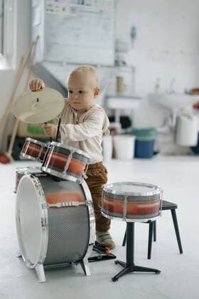 Toddler with toy drums model released Symbolfoto property released  KNSF05196