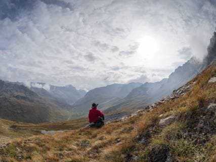 Border region Italy Switzerland, senior man having a break from hiking in mountain landscape at Piz Umbrail model released Symbolfoto  LAF02156