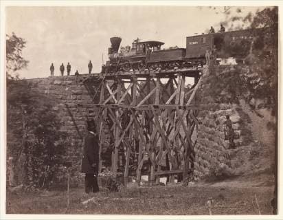 Bridge on Orange and Alexandria Rail Road, as Repaired by Army Engineers under Colonel Herman Haupt, 1865, Albumen silver print from glass negative, Photographs, Andrew Joseph Russell (American, 1830–1902), This view by Russell documents the engine Fire Fly testing the stability of a new wooden trestle bridge built quickly by the United States Military Railroad engineers to replace a masonry bridge destroyed by the Confederates  Copyright: Artokoloro AM170720_055135