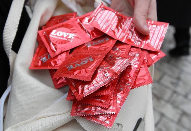 February 13, 2019 - Kiev, Ukraine - An activist shows free condoms during an action to mark the International Condom Day in Kiev, Ukraine, on 13 February 2019. The event organized by the AHF (AIDS Healthcare Foundation) in an effort to reduce the spread of HIV thru safe sex practices, and as an informal observance marked in conjunction with Valentine s Day. Ukraine has the second largest HIV epidemic in Europe on 2019, as reported. The International Condom Day seeks to promote the use of condoms as a means of preventing unwanted pregnancies and sexually transmitted infections. Kiev Ukraine - ZUMAg194 20190213_zap_g194_008 Copyright: xSergxGlovnyx