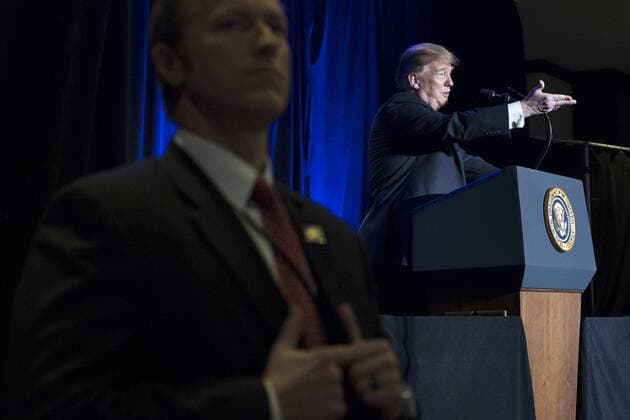US President Donald J. Trump (R) is seen behind a US Secret Service agent while delivering remarks at the Major County Sheriffs and Major Cities Chiefs Association Joint Conference, in Washington, DC, on February 13, 2019. Trump took the opportunity to deliver remarks on his border-security and immigration policy. Republican leaders are asking Trump to sign legislation that allocates about $1.375 billion for over fifty miles of physical barriers along the border. Signing the agreement would prevent another partial shutdown of the federal government that would begin 16 February.  WAX20190213222 MICHAELxREYNOLDS