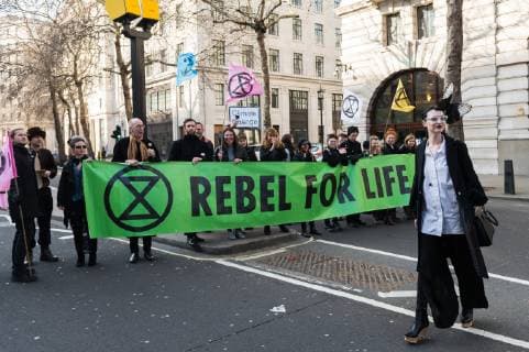 February 17, 2019 - London, Greater London, United Kingdom - Guest arrives at London Fashion Week as activists from Extinction Rebellion disrupt traffic and create gridlock between the event venues on 17 February, 2019. Protesters call for the British Fashion Council to influence fashion industry to stop the trend of excessive consumption and unsustainable growth in the face of climate change and ecological collapse. Textiles production contributes 1.2 billion tonnes of carbon emissions annually and textiles are the largest single source (34.8%) of microplastic pollution affecting marine life. London United Kingdom  - ZUMAn230 20190217_zaa_n230_198 Copyright: xWiktorxSzymanowiczx
