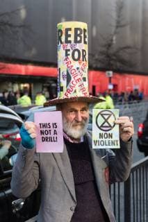 February 17, 2019 - London, Greater London, United Kingdom - Activist from Extinction Rebellion demonstrates outside London Fashion Week on 17 February, 2019. Protesters call for the British Fashion Council to influence fashion industry to stop the trend of excessive consumption and unsustainable growth in the face of climate change and ecological collapse. Textiles production contributes 1.2 billion tonnes of carbon emissions annually and textiles are the largest single source (34.8%) of microplastic pollution affecting marine life. London United Kingdom  - ZUMAn230 20190217_zaa_n230_207 Copyright: xWiktorxSzymanowiczx
