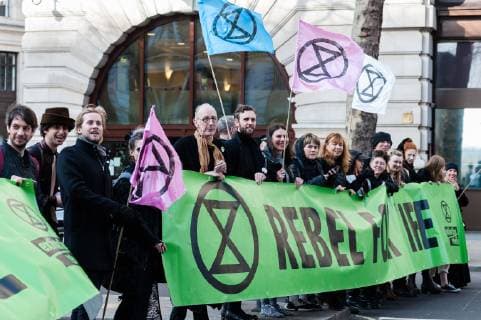 February 17, 2019 - London, Greater London, United Kingdom - Activists from Extinction Rebellion disrupt London Fashion Week by stopping traffic and creating gridlock between the event venues on 17 February, 2019. Protesters call for the British Fashion Council to influence fashion industry to stop the trend of excessive consumption and unsustainable growth in the face of climate change and ecological collapse. Textiles production contributes 1.2 billion tonnes of carbon emissions annually and textiles are the largest single source (34.8%) of microplastic pollution affecting marine life. London United Kingdom  - ZUMAn230 20190217_zaa_n230_199 Copyright: xWiktorxSzymanowiczx