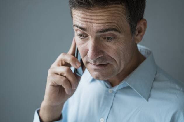 Portrait of worriedsman on cell phone model released Symbolfoto property released  JOSF02825