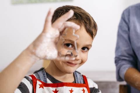 Portrait of smiling little boy looking through cookie cutter model released Symbolfoto property released  JRFF02345