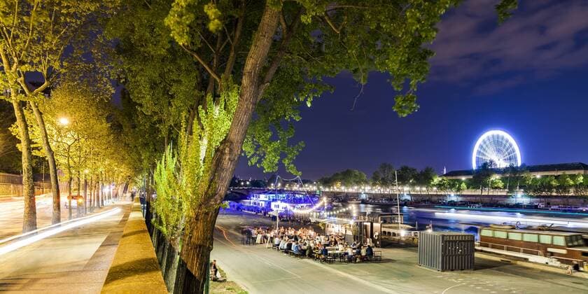 France, Paris, Champs-Elysees, Quai Anatole, people at River Seine bank at night  WDF04889