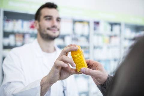 Close-up of harmacist giving pill box to customer in pharmacy model released Symbolfoto property released  WESTF23940