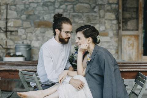 Affectionate happy bride and groom sitting at table model released Symbolfoto  ALBF00686