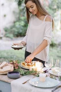 Woman preparing a romantic candelight meal outdoors model released Symbolfoto  ALBF00709
