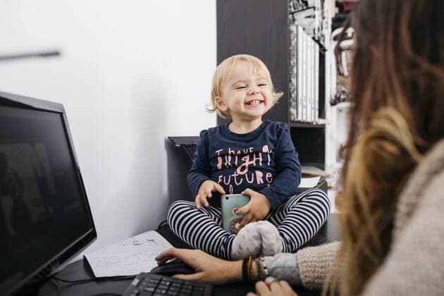Mother working at home with little daughter sitting on desk model released Symbolfoto property released  JRFF02107