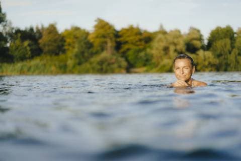 Portrait of smiling woman swimming in a lake model released Symbolfoto property released  KNSF05161