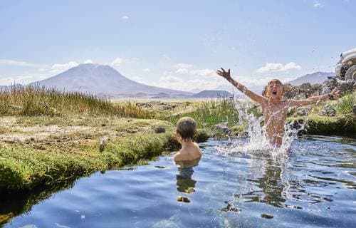 Chile, Salar del Carmen, two boys bathing in hot spring model released Symbolfoto  SSCF00037