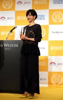 March 8, 2019, Tokyo, Japan - Japanese TV personality Christel Takigawa holds the trophy as she receives the Happy Woman Award 2019 for SDGs on the International Women s Day in Tokyo on Friday, March 8, 2019. Five women were awarded as they contributed to the promotion of gender equality and UN s SDGs.  (98742889)
