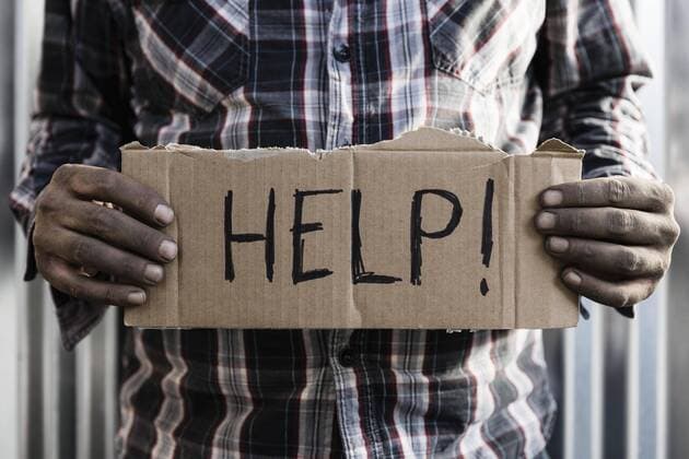 Homeless man holding help sign  Copyright: PeterxStark fStopImages1776031