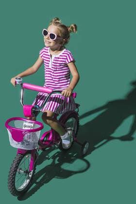 Carefree girl riding bicycle on green background  Copyright: VladimirxGodnik fStopImages1794004