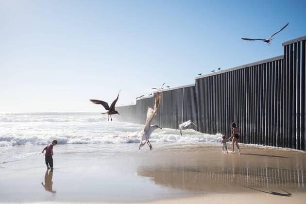 March 13, 2019 - Tijuana, Baja California, Mexico - Kids are seen playing near the diving border wall between the United States and Mexico where many asylum seekers have crossed. In February 2019, around 76,000 fled from the southern border into the United states in order to find a better live. Tijuana Mexico - ZUMAs197 20190313_zaa_s197_197 Copyright: xMeganxJelingerx