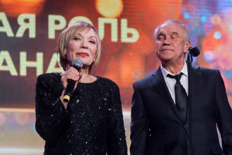 MOSCOW, RUSSIA â€“ MARCH 30, 2019: Actor Sergei Garmash (R) looks on as actress Yelena Koreneva accepts an award for Best Supporting Actress for her role in Sergei Livnev s film Van Goghs at the 32nd Nika Film Award Ceremony. Vyacheslav Prokofyev TASS  TS0A6763