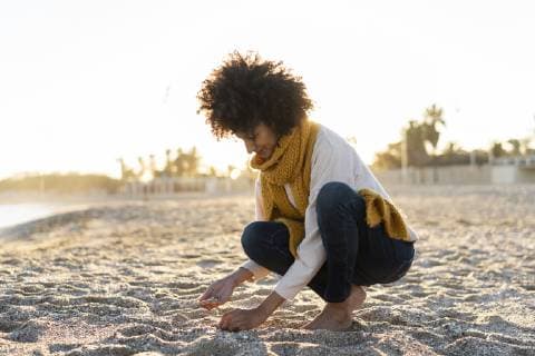 Woman collecting seashells on the beach model released Symbolfoto  AFVF02143
