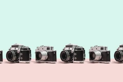 Photo cameras organized in a row over colorful background  DRBF00129