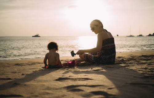 Thailand, Koh Lanta, mother playing with little daughter on the beach by sunset model released Symbolfoto  GEMF02653
