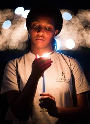 News Themen der Woche KW14 News Bilder des Tages Illustration picture shows a young Rwandese with candle during a vigil service on the 25th anniversary of the Rwandan genocide at the Amahoro National Stadium in Kigali, the Republic of Rwanda, Sunday 07 April 2019. During the Rwandan genocide between 500000 and 1 million Tutsi where killed by the Hutu government.  BENOITxDOPPAGNE 05564385