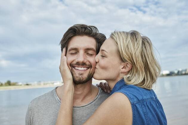 Happy young couple kissing on the beach model released Symbolfoto  RORF01680