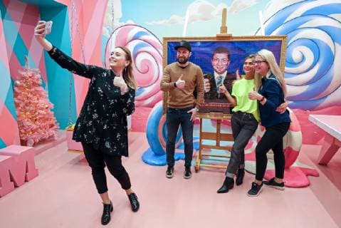 ST PETERSBURG, RUSSIA - APRIL 18, 2019: Visitors take a selfie at a 15kg picture showing a likeness of Ukraine s presidential candidate Volodymyr (Vladimir) Zelensky with the national Ukrainian colours behind, made from some 3,000 Roshen sweets, at Sladky (Sweet) Museum at Nevsky Prospekt in St Petersburg; Roshen is a confectionery corporation owned by Ukraine s incumbent president Poroshenko who is also taking part in the 2019 Ukrainian presidential election. Alexander Demianchuk TASS  TS0A8A19