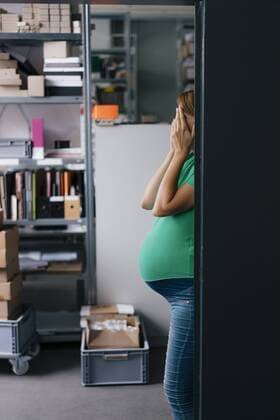 Pregnant woman hiding her face in office model released Symbolfoto property released  KNSF05450