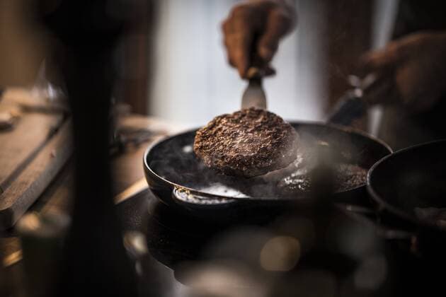 Man frying beef patties in a pan model released Symbolfoto property released  MJRF00069