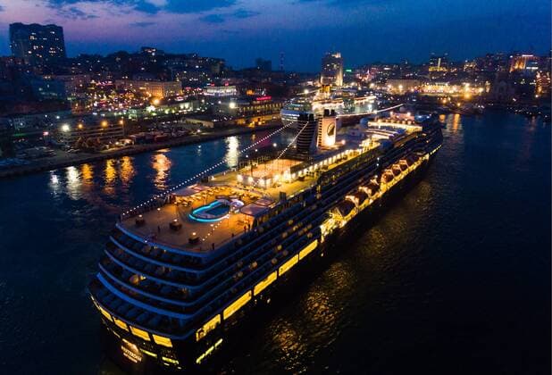 VLADIVOSTOK, RUSSIA - APRIL 22, 2019: The Westerdam cruise ship (front) operated by Holland America Line unberthing at the port of Vladivostok on Russia s Pacific coast. Yuri Smityuk TASS  TS0A923A