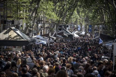 April 23, 2019 - Barcelona, Catalonia, Spain - A crowd of people seen circulating at the book stalls during the Sant Jordi day celebration..The festivity of Sant Jordi is celebrated in conjunction with Book Day and the Fair of Roses, symbols of culture and love. Knight Saint Jordi died on April 23, 303.The cult of Saint Jordi was established in Catalonia during the 8th century but it is at the end of the 19th century, with the Catalan Renaixenca that installed as the most celebrated patriotic, civic and cultural day in Catalonia. The streets of the cities and towns of Catalunya are filled with stalls with books and roses for sale. Tradition orders that man should give a rose to his partner and the woman a book in turn. Barcelona Spain - ZUMAs197 20190423_zaa_s197_071 Copyright: xPacoxFreirex