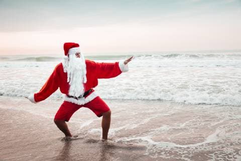 Thailand, man dressed up as Santa Claus posing on the beach at sunset model released Symbolfoto  HMEF00215