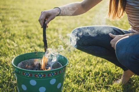 Woman barbecueing on a meadow, partial view model released Symbolfoto  JSCF00124
