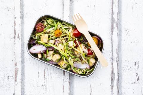 Lunch box of zoodles with fried tofu, red quinoa, red onions and tomatoes  LVF07811