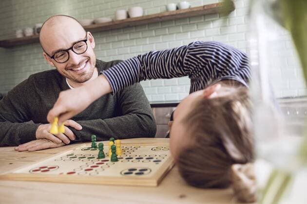 Father and daughter playing board game in the kitchen model released Symbolfoto property released  MCF00018