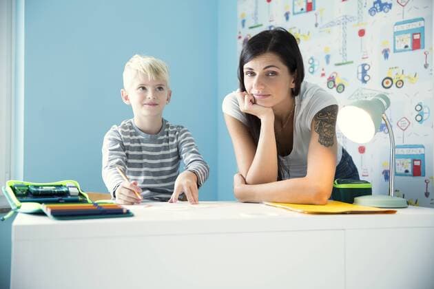 Portrait of mother with son doing homework at desk model released Symbolfoto property released  MFRF01214