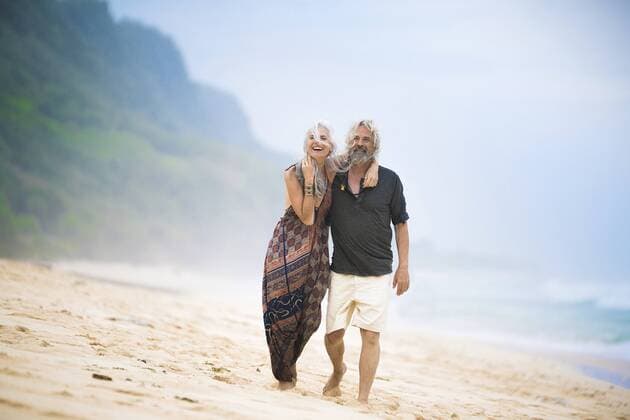 Happy senior hippie couple strolling side by side on the beach model released Symbolfoto  SBOF01720