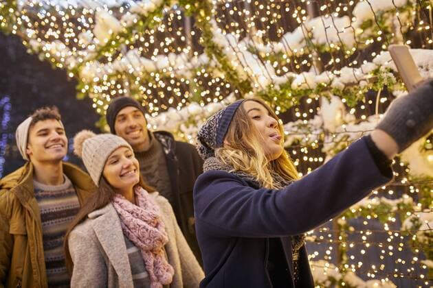 Happy friends in winter decoration taking a selfie model released Symbolfoto property released  ZEDF01883