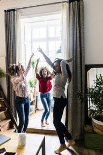 Three women at home having a party and dancing model released Symbolfoto property released GIOF05550